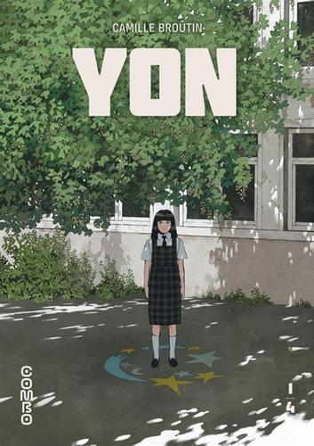 Une jeune fille aux cheveux noirs, vêtue d'un uniforme scolaire sombre se tient debout et seule au centre d'une cour d'école. À ses pieds, un cercle magique avec des étoiles jaunes dessiné sur le sol. En arrière-plan, une façade de bâtiment gris clair est partiellement couverte par un feuillage vert dense. Le titre "Yon" est écrit en grosses lettres blanches en haut de la couverture.